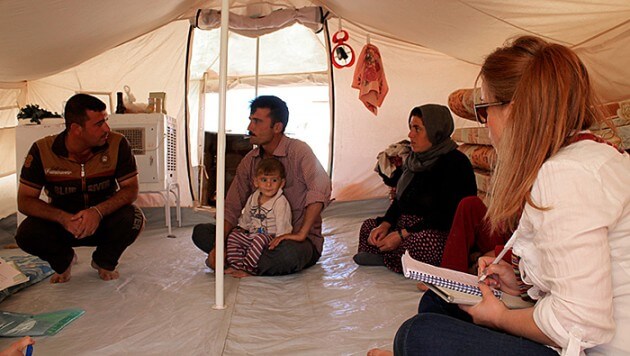 Ala Lattif (right) interviews a group of refugees for Zhin magazine. Photo: Zhin Magazine