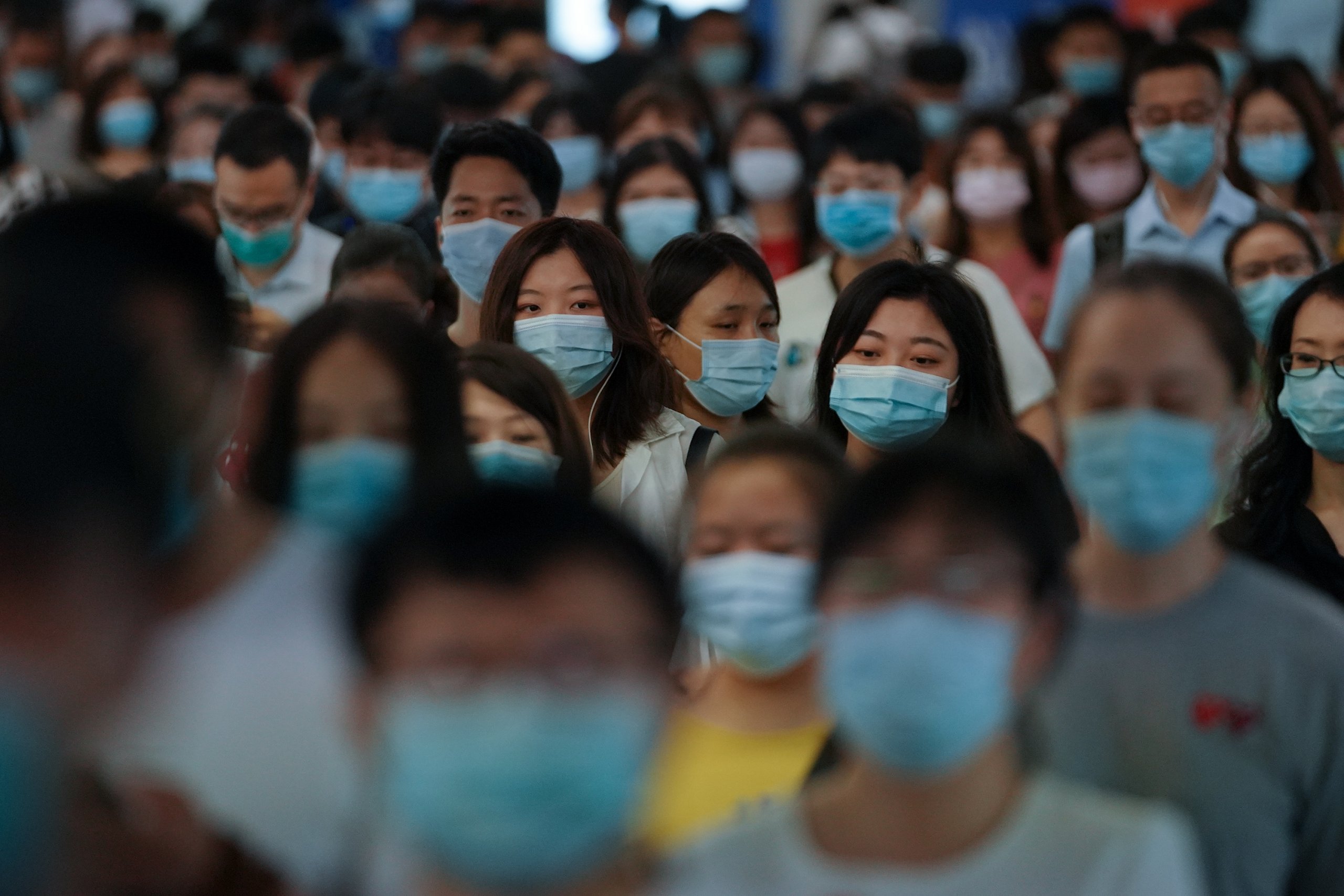 People wearing face masks walk in a subway station during morning rush hour on July 20, 2020 in Beijing, China