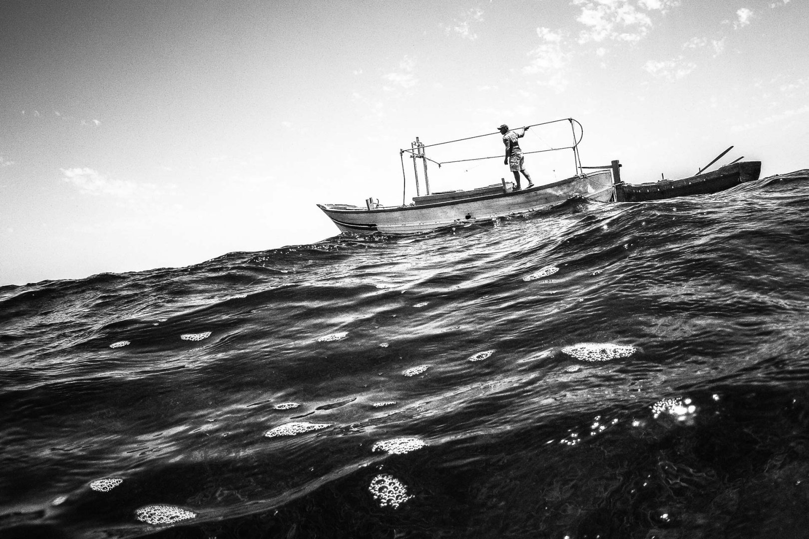 a black and white photo of a fishing boat in the kerkennah islands