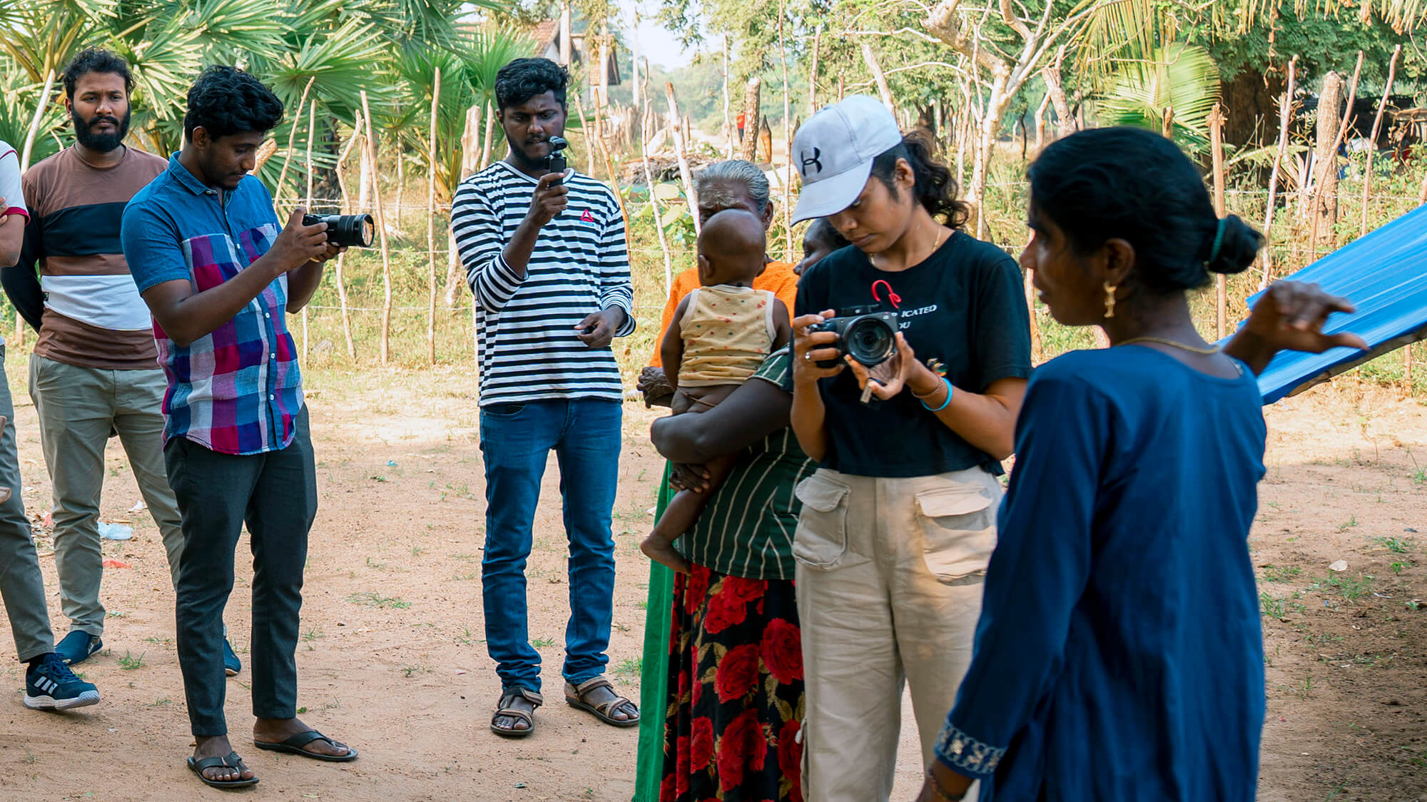 a group of Sri Lankan journalists interview a woman